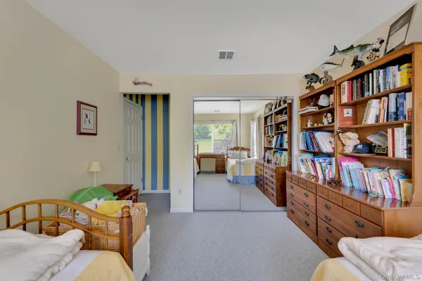 a living room with lots of furniture and a book shelf