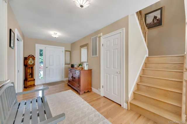 a view of entryway with wooden floor and stairs