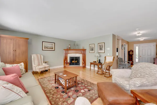 a living room with furniture a fireplace and a table