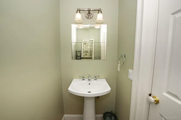 a bathroom with a sink a mirror and a window