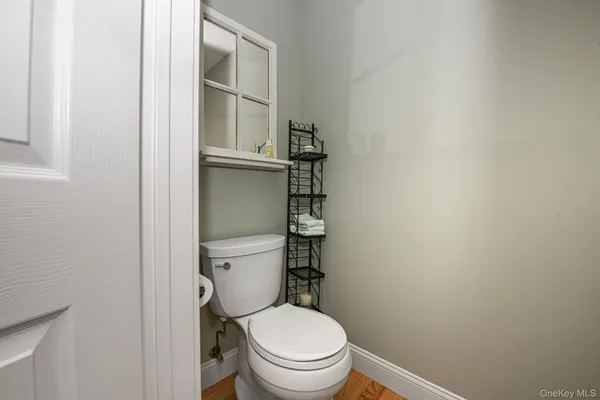 a white toilet sitting next to a shower