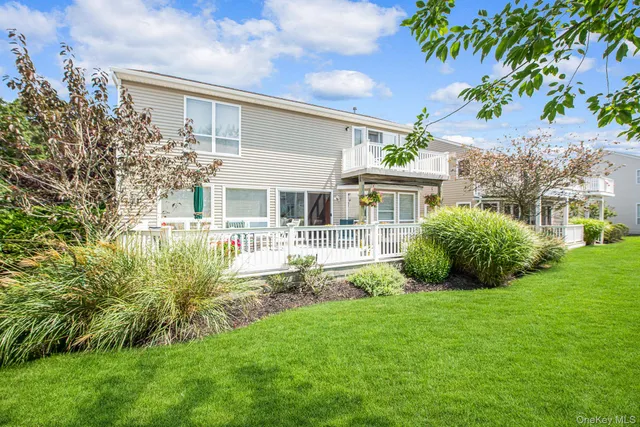 a view of house with backyard and a patio