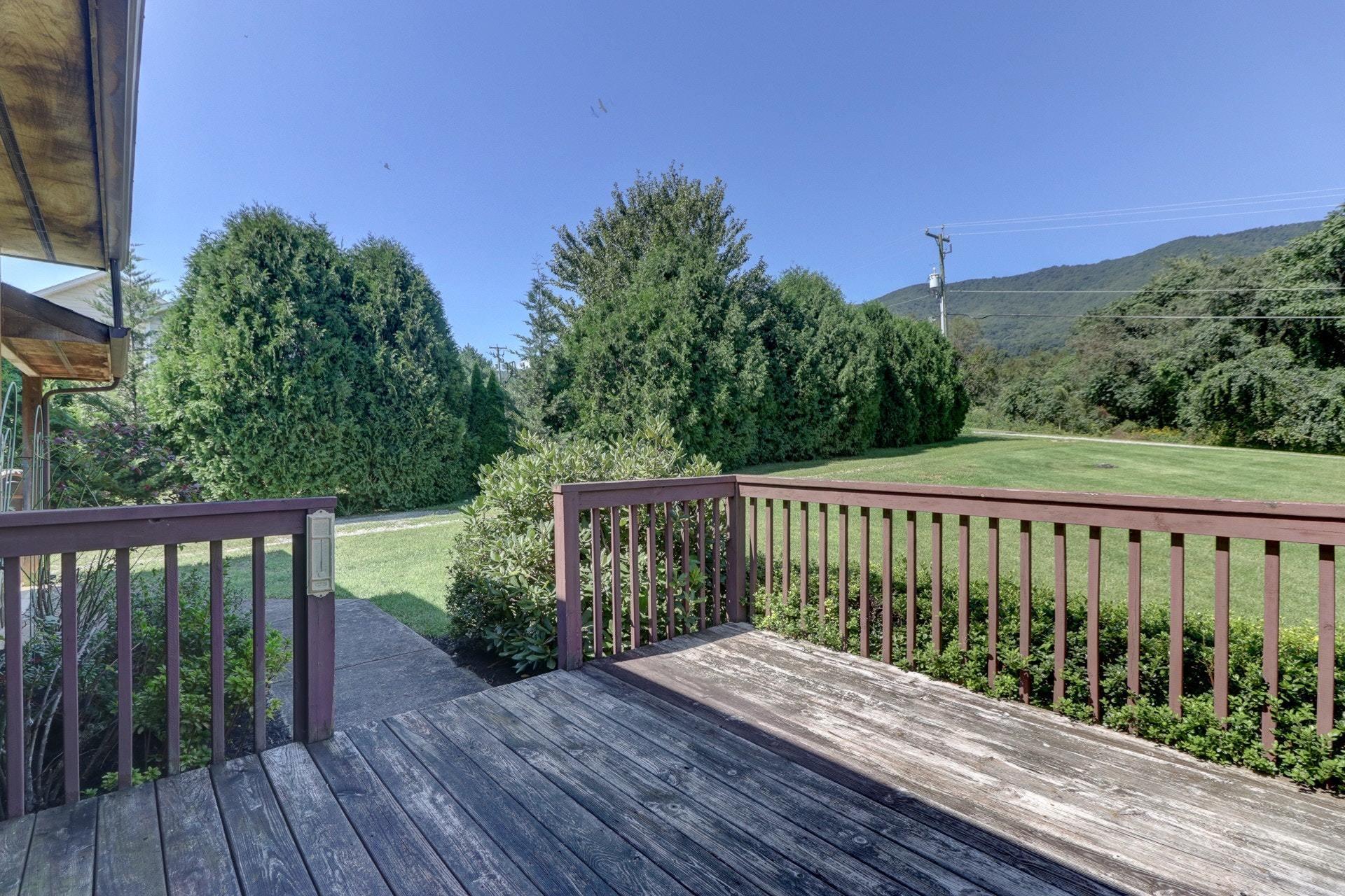 5331 Bethlehem Road Boones Mill, VA 24065 - Photo 2 of 21 a balcony with wooden floor and yard in the back