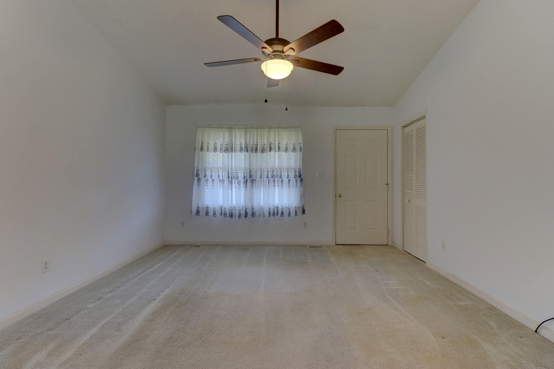 5331 Bethlehem Road Boones Mill, VA 24065 - Photo 4 of 21 an empty room with ceiling fan and window