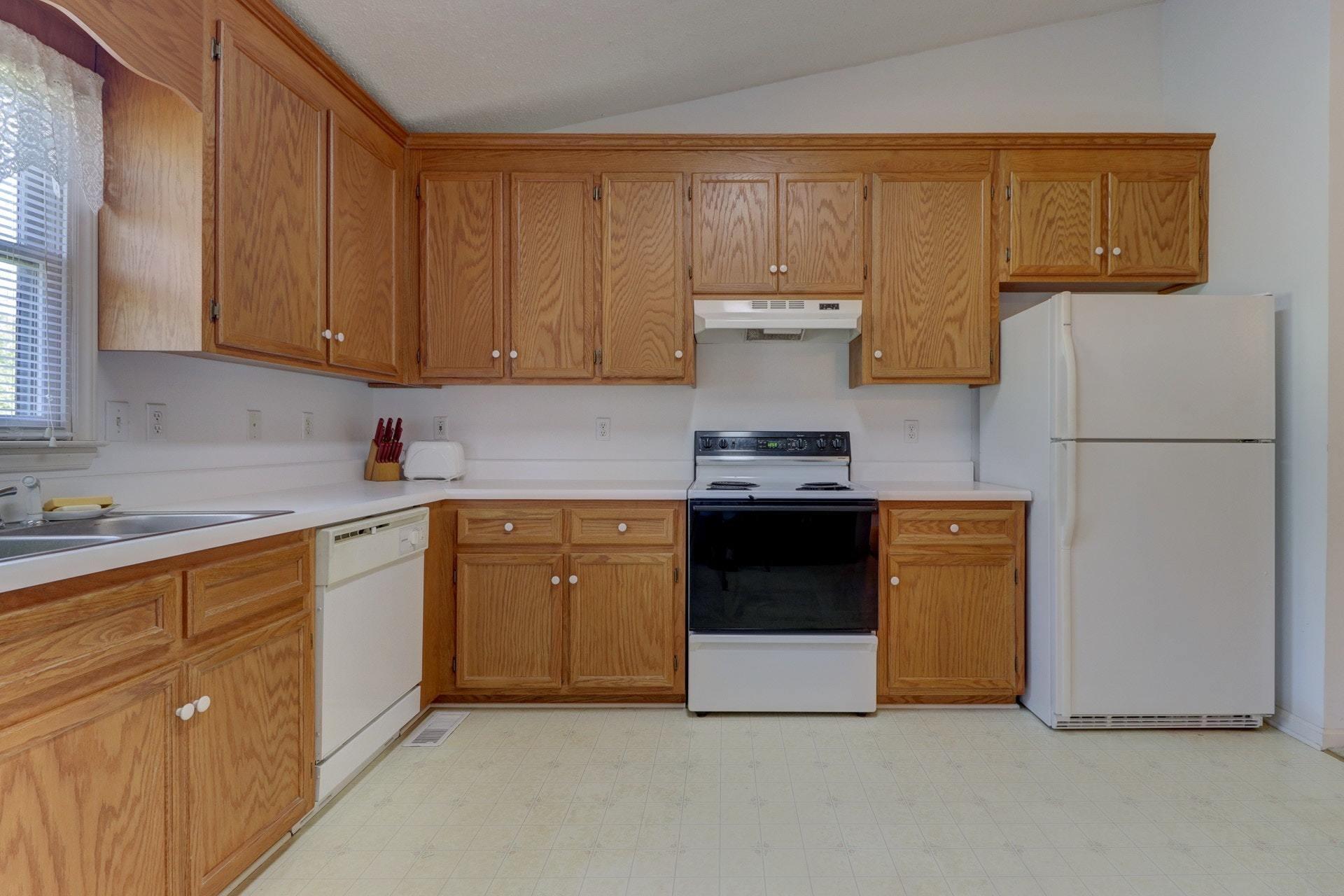 5331 Bethlehem Road Boones Mill, VA 24065 - Photo 8 of 21 a kitchen with stainless steel appliances granite countertop a stove a sink and a refrigerator