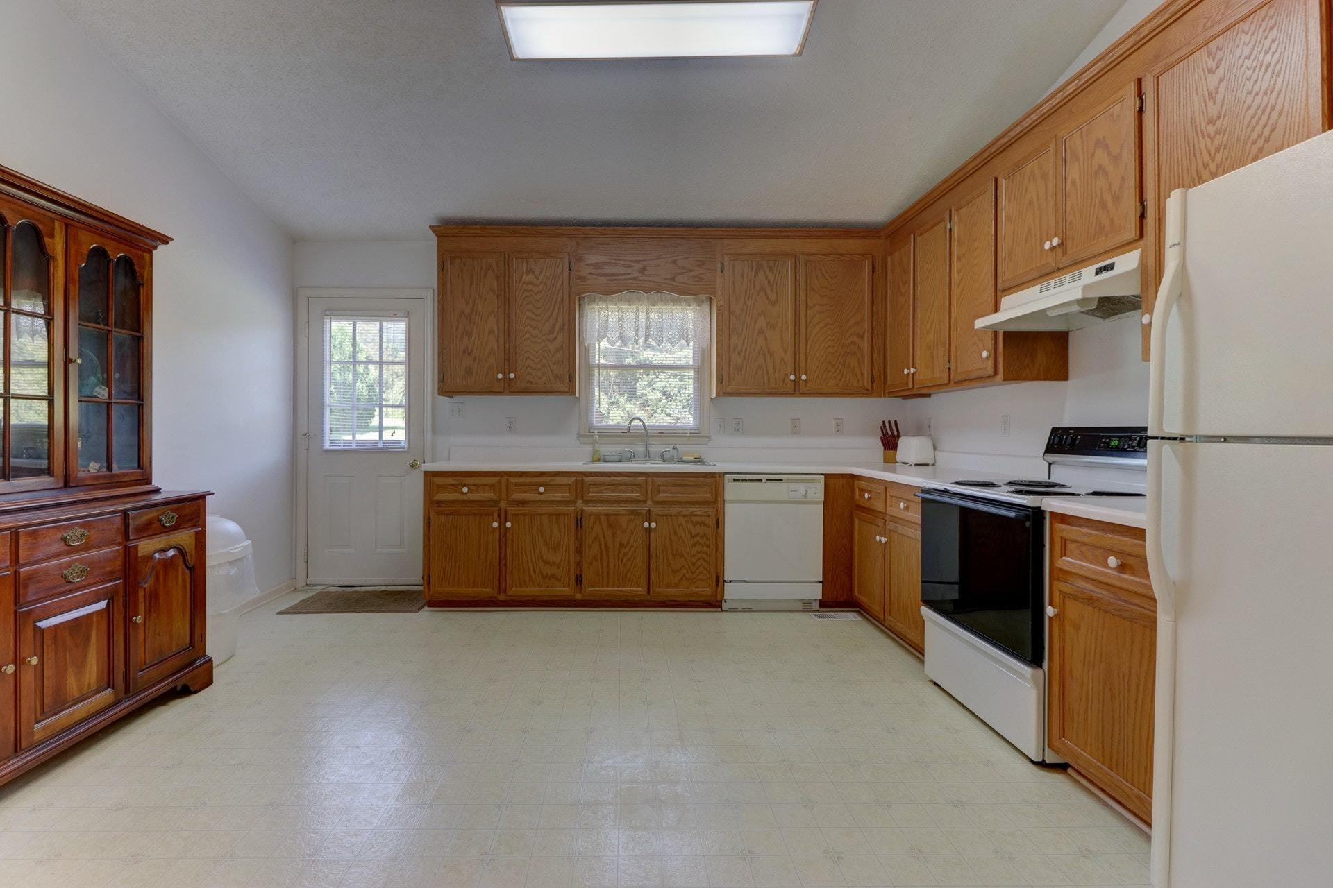 5331 Bethlehem Road Boones Mill, VA 24065 - Photo 9 of 21 a kitchen with stainless steel appliances a stove sink and cabinets