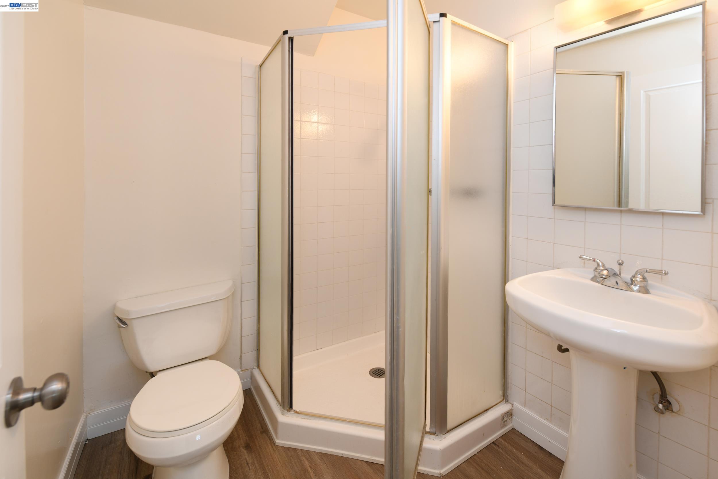 205 Muir Road Martinez, CA 94553 - Photo 11 of 20 a bathroom with a toilet a sink and a mirror