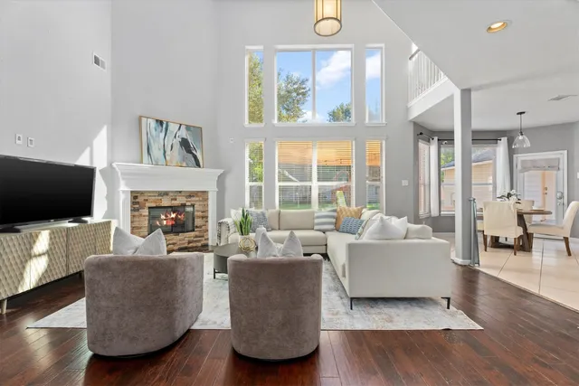 a living room with furniture a flat screen tv and a fireplace
