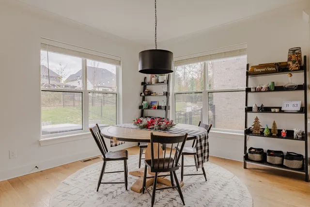a dining room with furniture and wooden floor