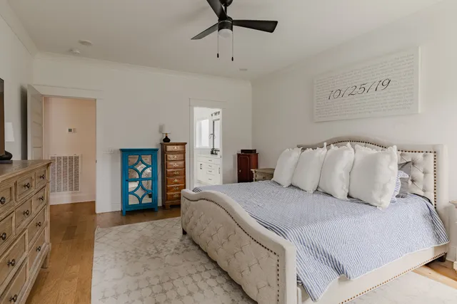 a bedroom with a bed and ceiling fan