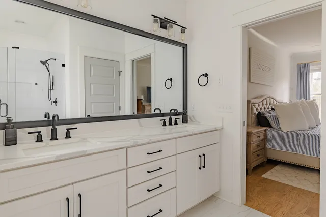a bathroom with a double vanity sink and mirror