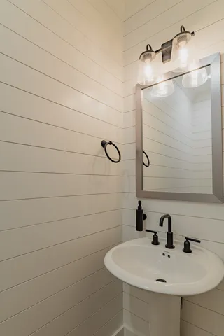 a bathroom with a sink and mirror