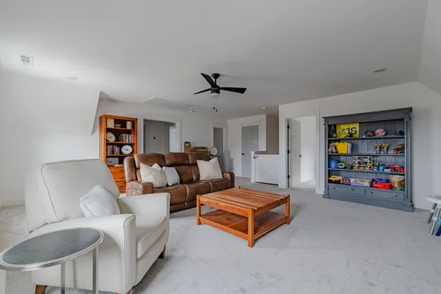 a living room with furniture and a bookshelf