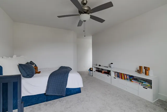 a living room with furniture and a book shelf