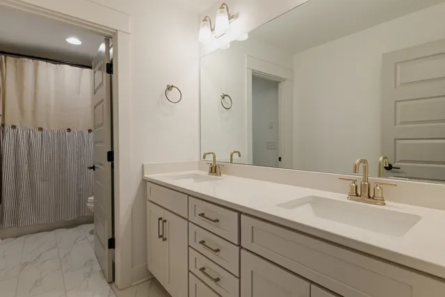 a bathroom with a sink double vanity and a mirror