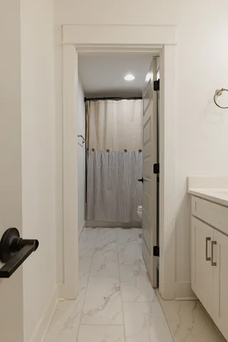 a bathroom with a shower and a sink