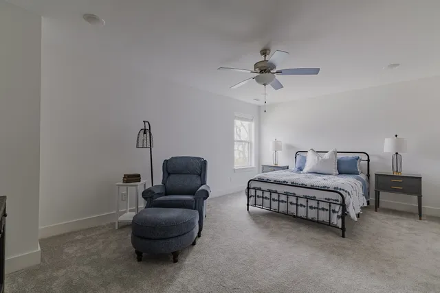 a living room with furniture a ceiling fan and a rug