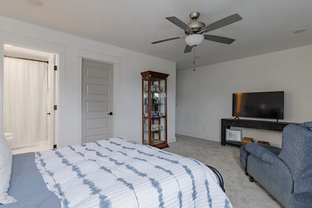 a bedroom with a bed and a television