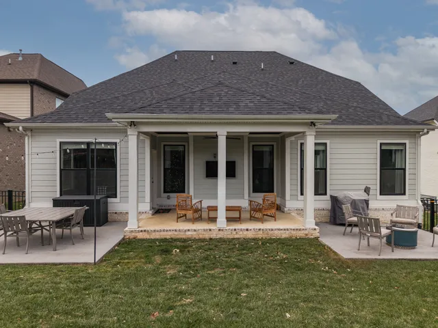 a house view with outdoor seating space and garden