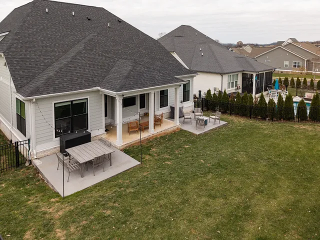 a view of a house with backyard and porch