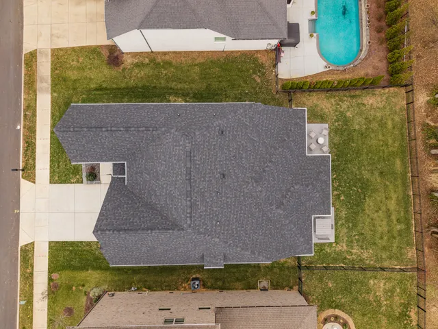 an aerial view of a house with a yard