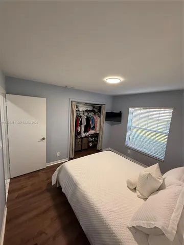 a bedroom with a large bed and a window