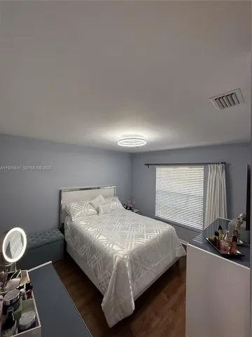 a bedroom with bed and window