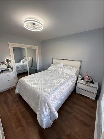a bedroom with bed and a chandelier