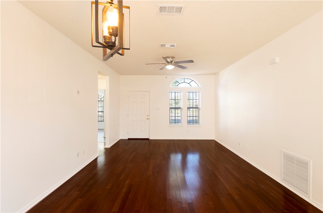 1833 Promise Corpus Christi, TX 78412 - Photo 4 of 19 an empty room with wooden floor and windows