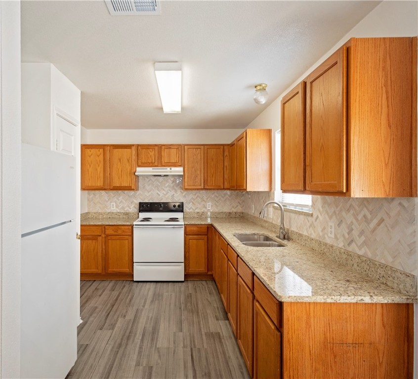 1833 Promise Corpus Christi, TX 78412 - Photo 6 of 19 a kitchen with a sink a stove cabinets and wooden floor