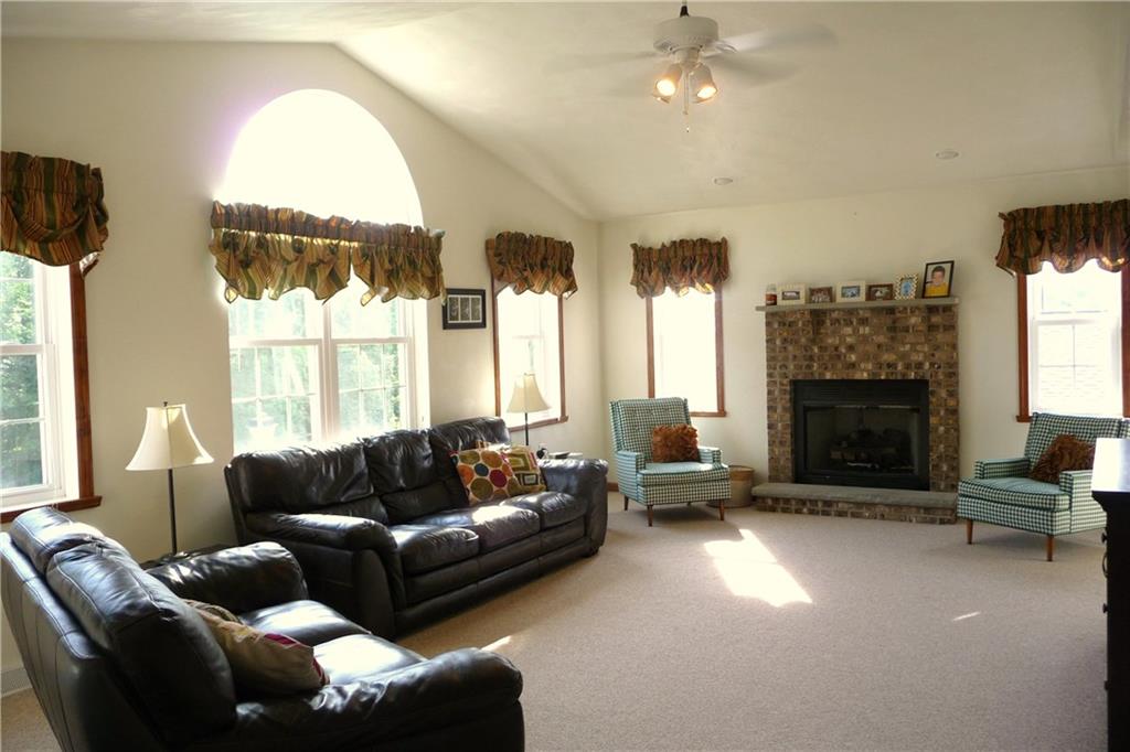 386 Lemmon Road Latrobe, PA 15650 - Photo 3 of 25 Living Room with gas log brick fireplace and high ceilings. Palladium window lets a lot of light in! Neutral colors throughout on walls and carpeting too. Ceiling fan in most rooms and dimmer switches too!