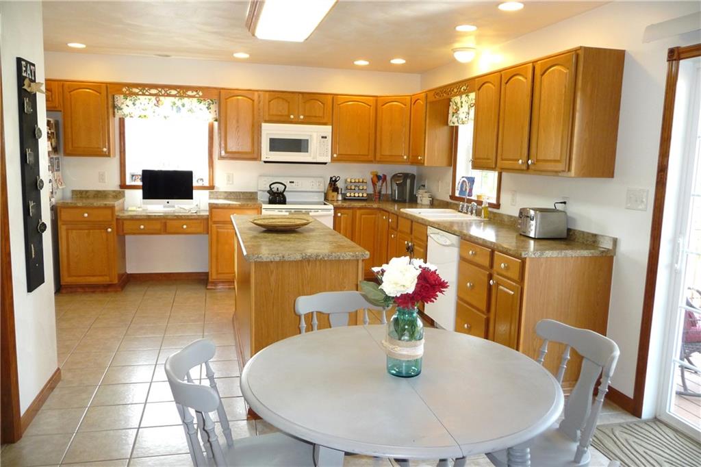 386 Lemmon Road Latrobe, PA 15650 - Photo 5 of 25 Wonderful kitchen with island, huge pantry, ceramic tiled flooring, and all kitchen appliances go with the house too! Sliding glass door leads to deck and rear yard. Very open and flowing floor plan.