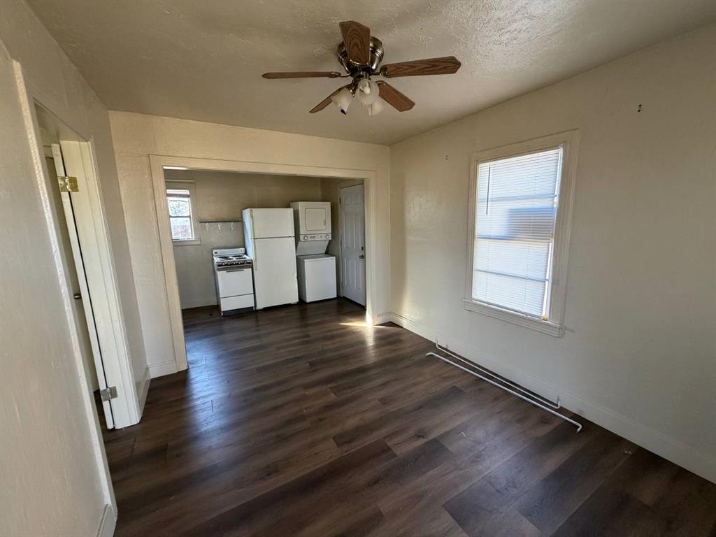 814 Tennessee Street Graham, TX 76450 - Photo 3 of 10 wooden floor in an empty room with a window