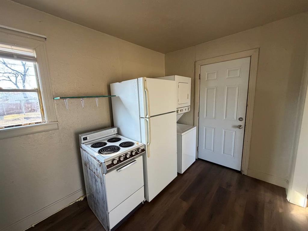 814 Tennessee Street Graham, TX 76450 - Photo 9 of 10 a white refrigerator freezer and a stove sitting inside of a kitchen