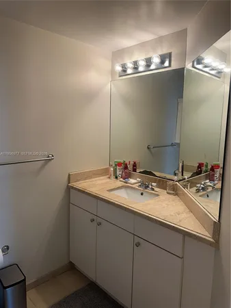 a bathroom with a sink and mirror