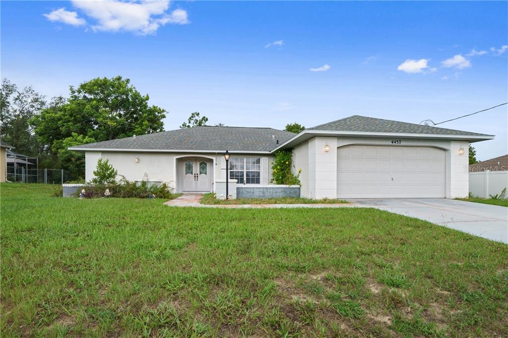 4457 Dior Road Spring Hill, FL 34609 - Photo 1 of 1 a front view of house with yard and green space