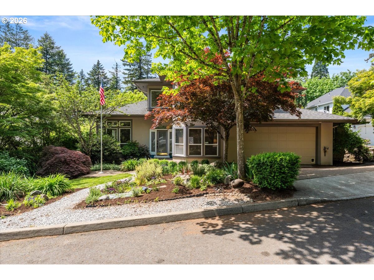 12431 Southwest 55th Place Portland, OR 97219 - Photo 1 of 40 a front view of a house with a yard and outdoor seating