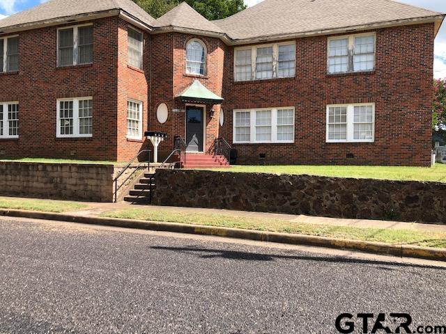 a front view of a house with a yard and a garage