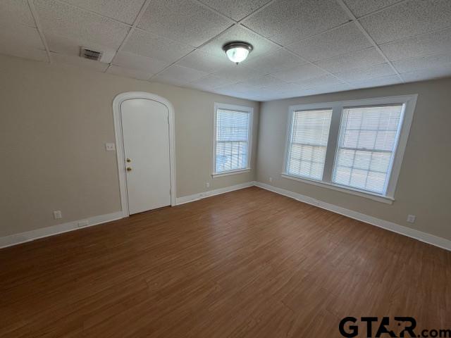 923 North Tyler Avenue Tyler, TX 75702 - Photo 3 of 9 an empty room with wooden floor and windows