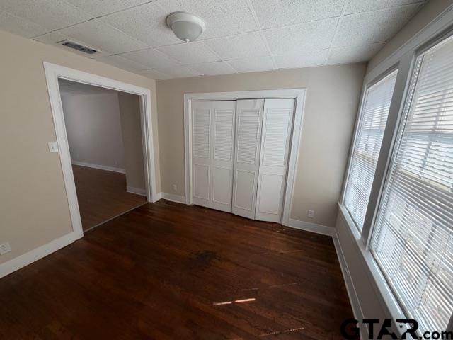 923 North Tyler Avenue Tyler, TX 75702 - Photo 6 of 9 an empty room with wooden floor and windows