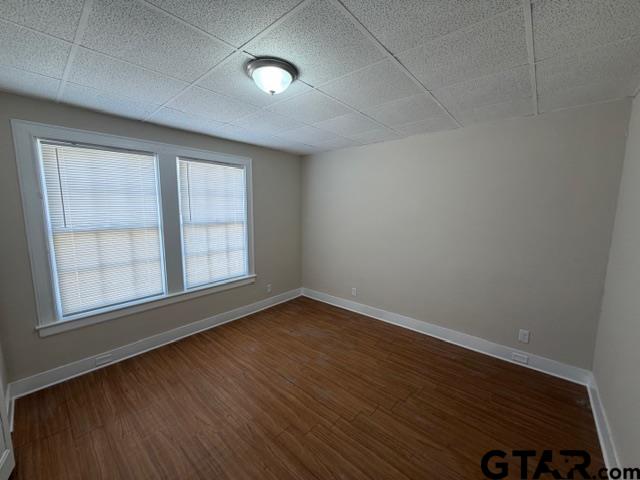 923 North Tyler Avenue Tyler, TX 75702 - Photo 8 of 9 an empty room with wooden floor and windows