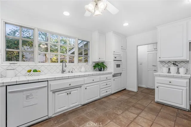 a spacious bathroom with a granite countertop sink mirror and a bathtub