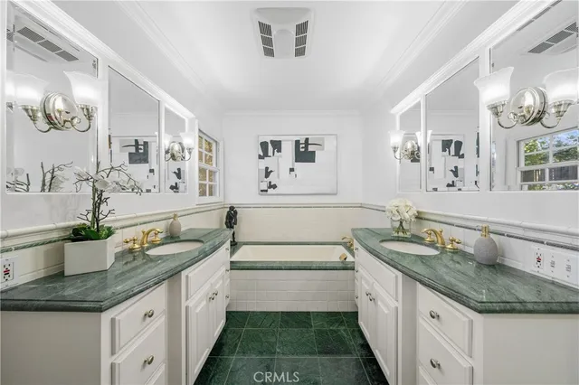 a spacious bathroom with a granite countertop double vanity sink and a mirror