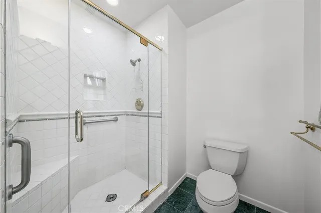 a bathroom with a shower a toilet and sink