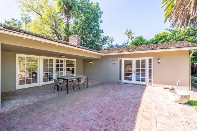 a view of a house with backyard sitting area and garden