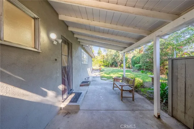 a view of a porch with chairs and backyard