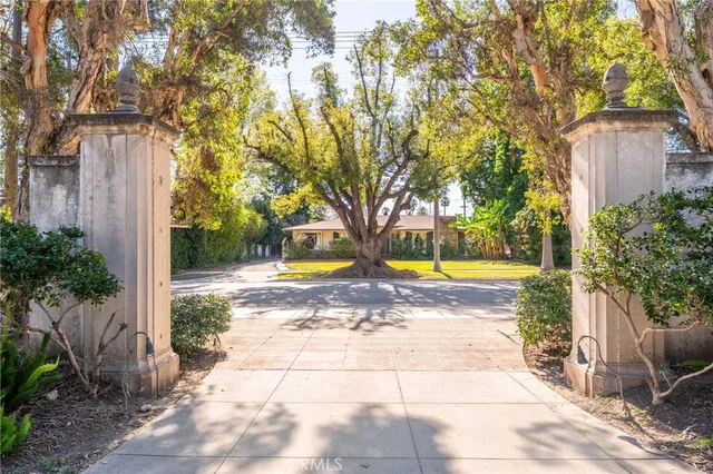 a view of swimming pool with sitting area and trees around