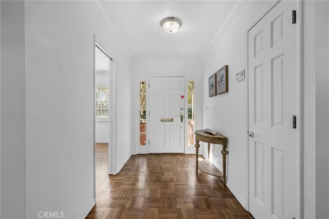 a view of a hallway with entryway and stairs