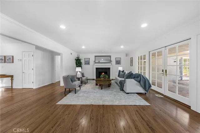a living room with furniture a fireplace and wooden floor