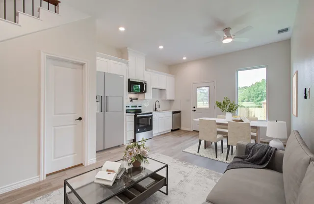 a kitchen with appliances a sink and cabinets